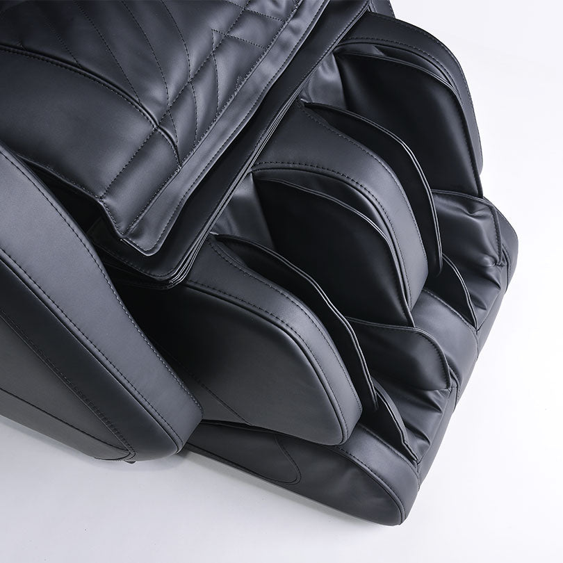 Close-up of JPMedics Kawa Massage Chair’s black leather leg and foot section with cushions.
